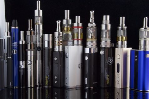 Pic Credit: Jon Williams A line of different types of Vapes. Most consist of a bottom battery (tank) and a top tank that holds various flavored juices. 