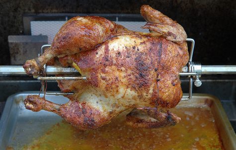 A Rotisserie Chicken perfectly roasted on the stake. 