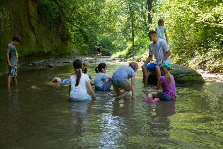 Teacher Collin Reichert explores a stream at Ledges with students involved in TCA Summer Experience 2018.