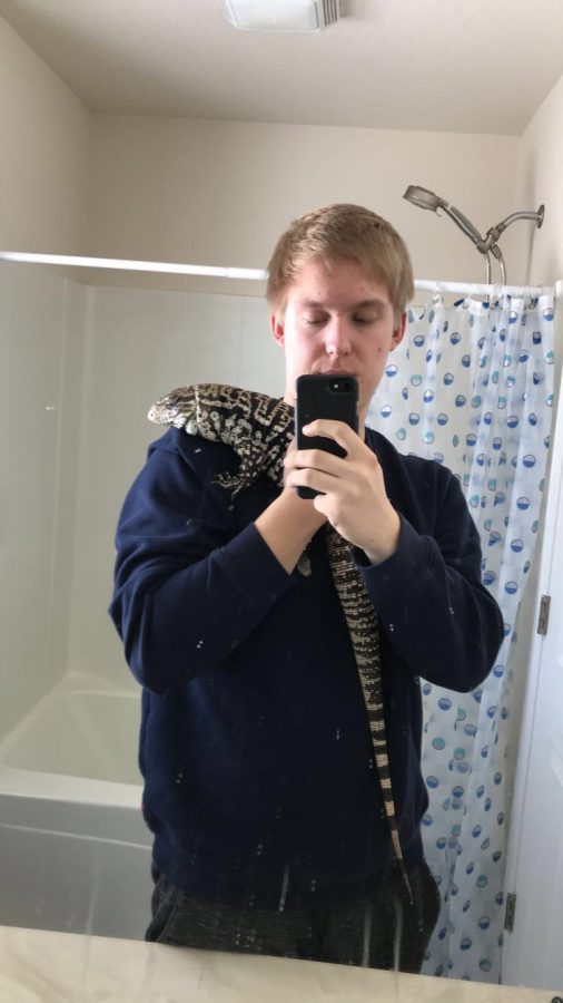 Sean takes a selfie with his Tegu. 