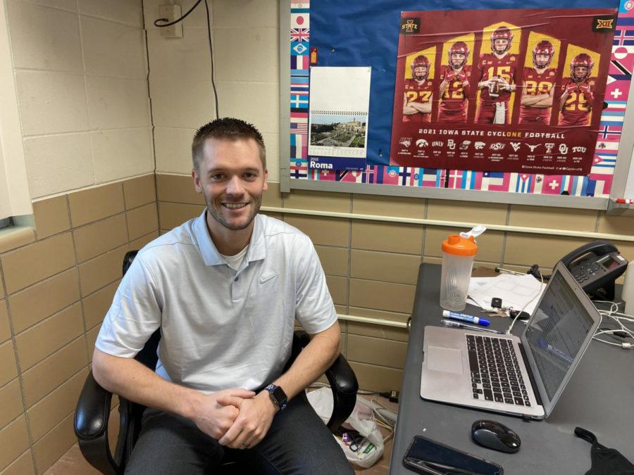 Mr.+Landhauser+sitting+at+his+desk+in+his+classroom.+