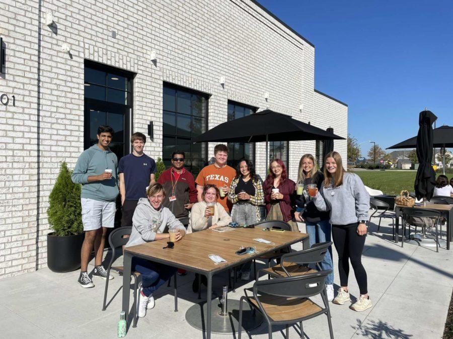 The Web staff poses outside Burgies with hands full of drinks. 