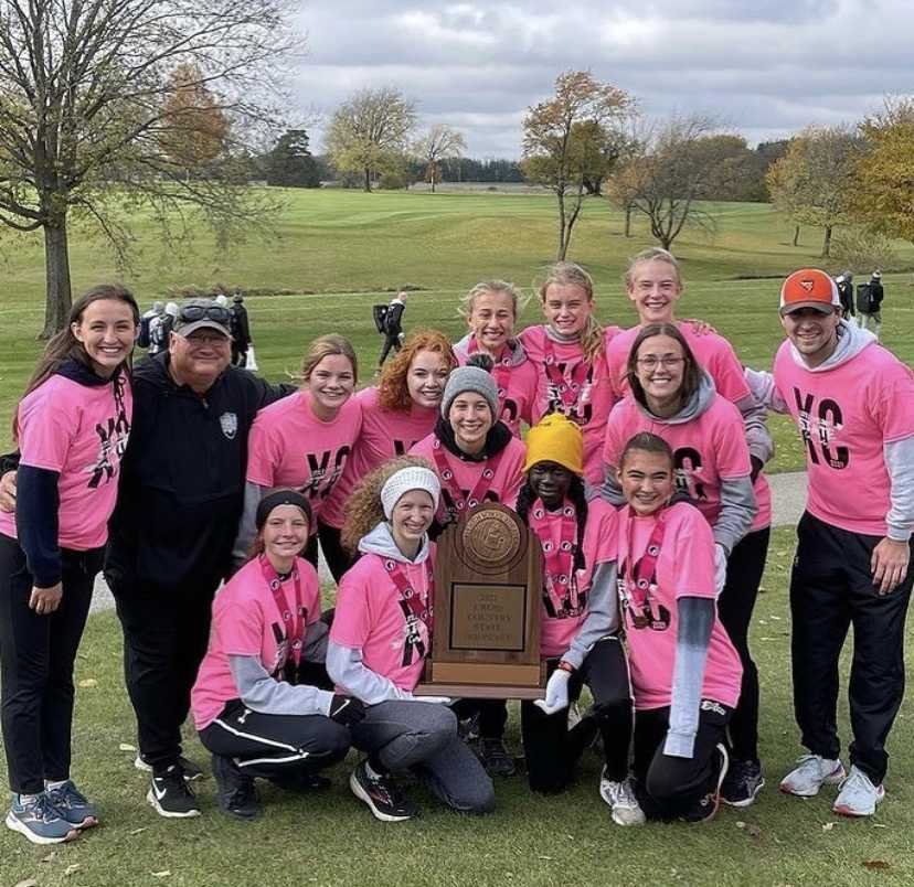 Ames girls and coaches cradle their trophy.