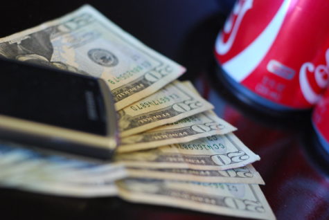 Money, cell phone and soda by espensorvik is licensed under CC BY 2.0