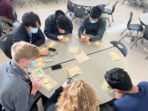 Members of key club gather in the lunchroom to decorate cookies that they will later be donating. 