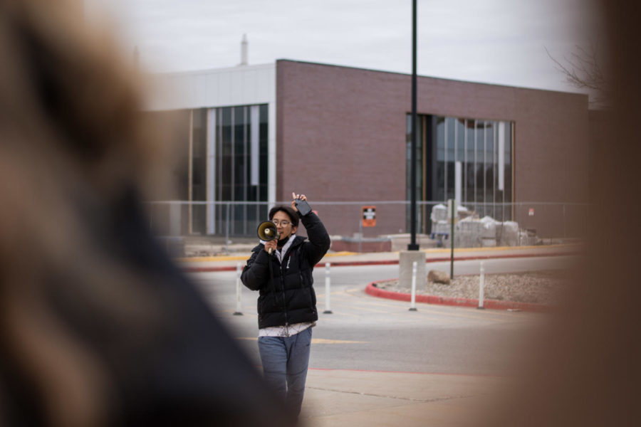 David Lee directs the crowd of students on the walkout path. 