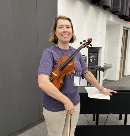 Ms. Driskell, standing next to two of her favorite instruments, the violin and the piano.