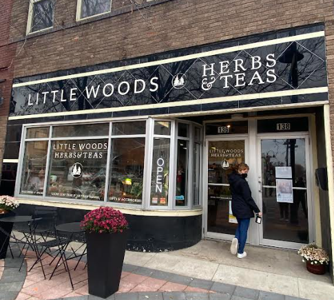 WEB Staff member Elaina Johnson entering Little Woods tea shop on Main Street