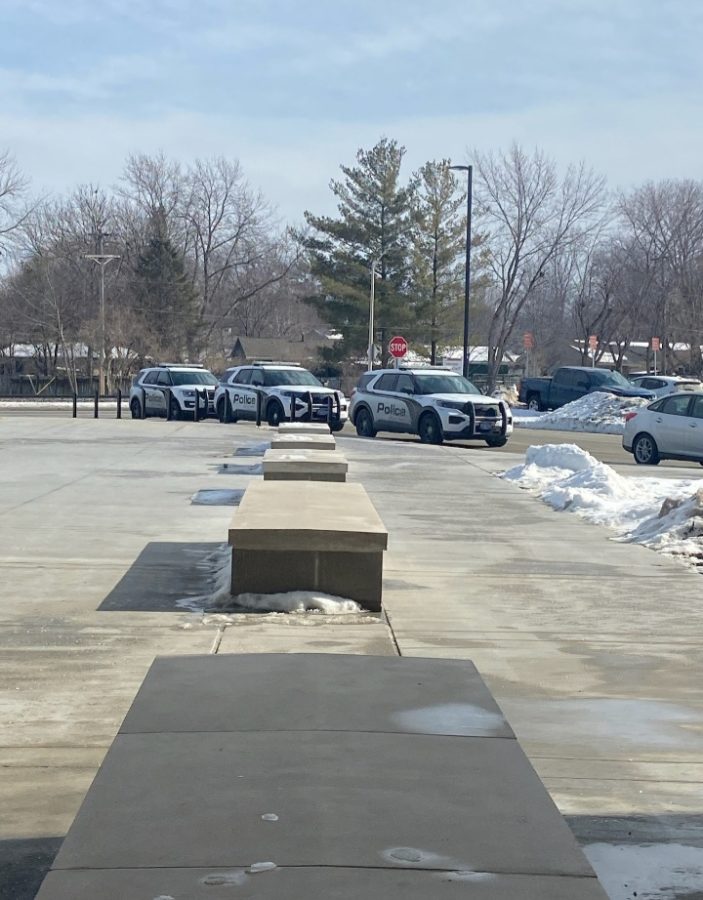 Ames High Police stand outside Ames High during February 6th Shelter-In-Place.