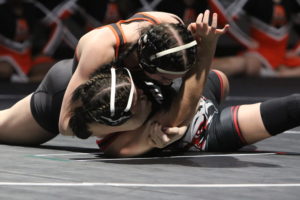 Varsity wrestler Alexis (Lexi) Winkey '23 pins opponent in Girl's Dual