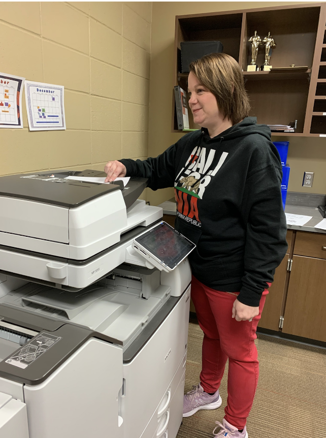 Stefanie Day works at the printer at Sawyer Elementary.