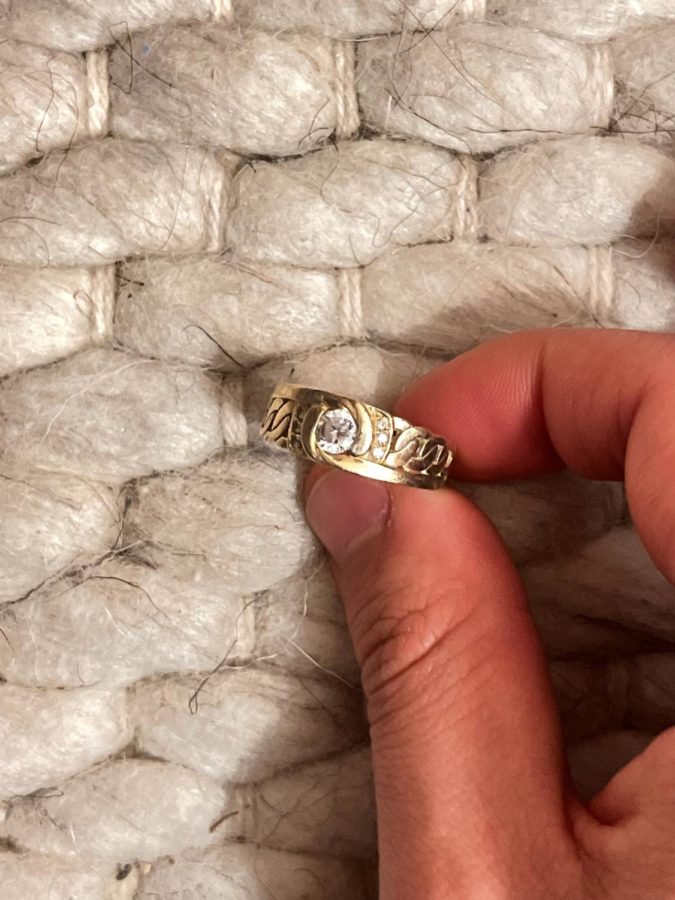 David Lee 23 holds his ring between his fingers. The ring represents different aspects of Lees identity when placed on different fingers.