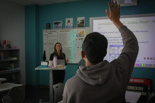 Senior Akshay Sarda raises his hand to answer a journal prompt provided by the RULER curriculum. RULER aims to provide students with the tools needed to regulate their emotions beyond high school. 