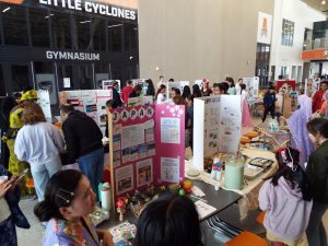 Students and family members explore various cultural booths at the Ames High Culture Fair.