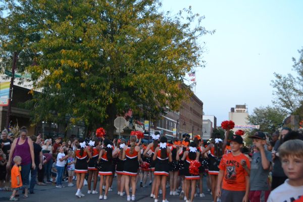 Ames high cheerleaders pass through mainstreet.
