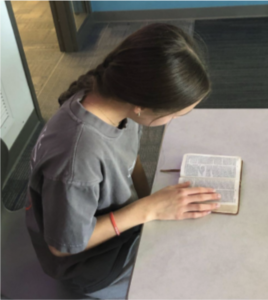 Freshman Avery Vance spends her little free time reading her travel Bible during school.