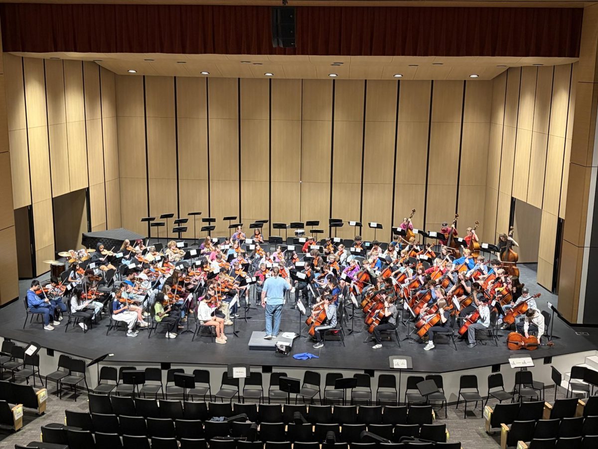 The 7th and 9th grade orchestras rehearse together for the first time before the concert.
