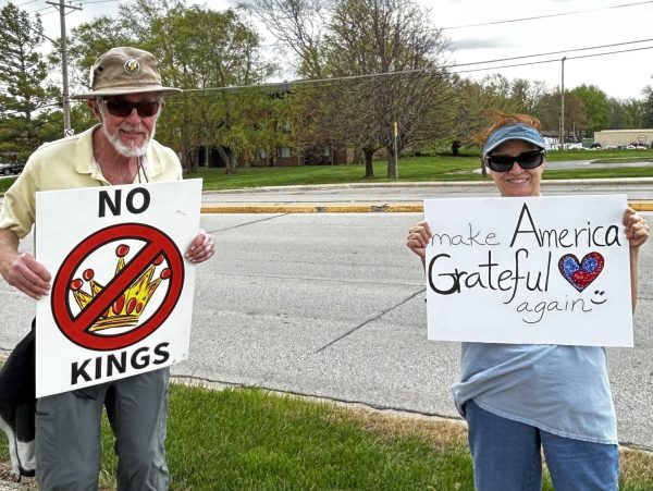 Two of the protestors holding up their signs. 